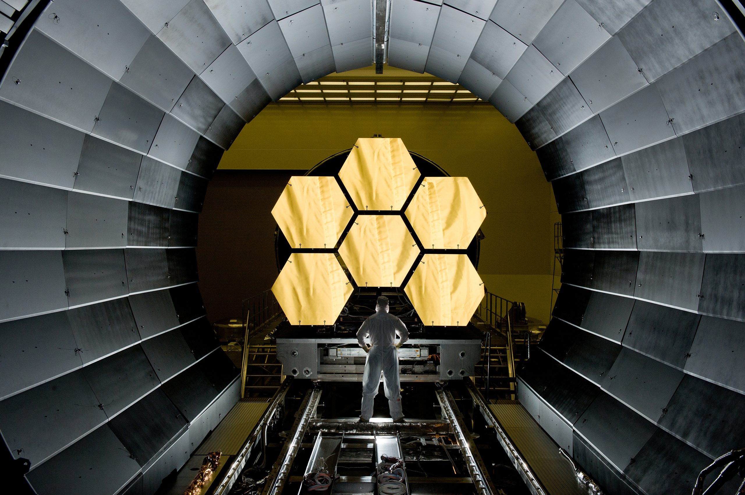 Ernie Wright beside James Webb Space Telescope mirror segments